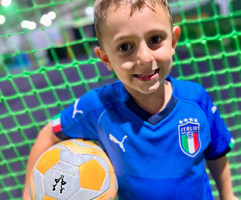 Birthday boy holding soccer ball